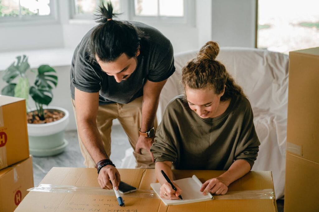 man and woman, couple, moving boxes, packing, first apartment checklist